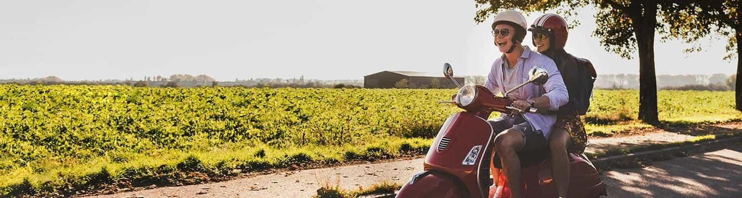 Young couple riding a moped