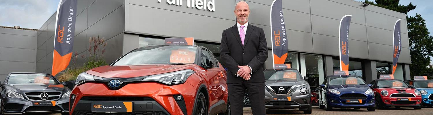 Man stood outside of an RAC Approved Dealer showroom